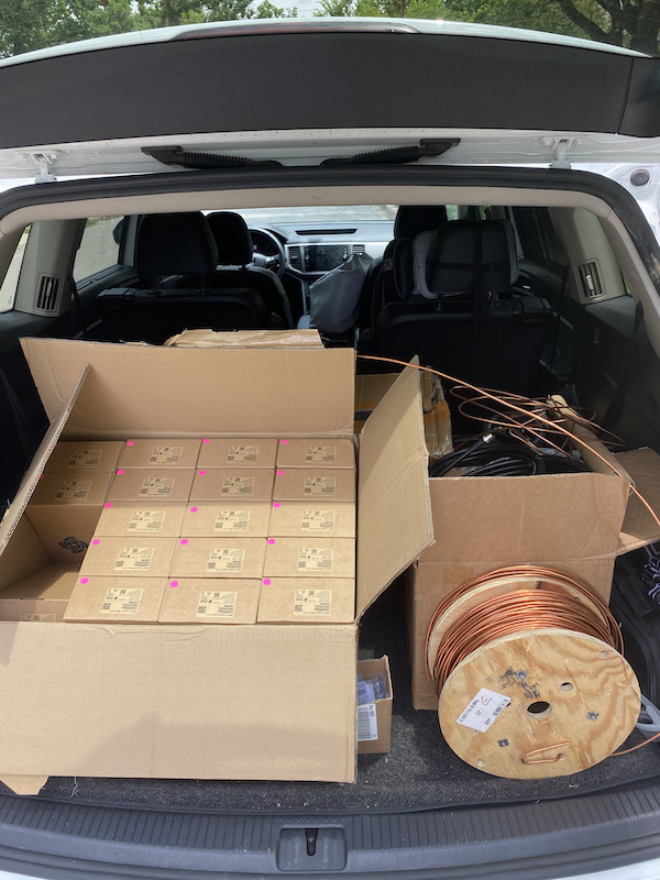 A car full of little boxes, cables, and a spool of copper wire