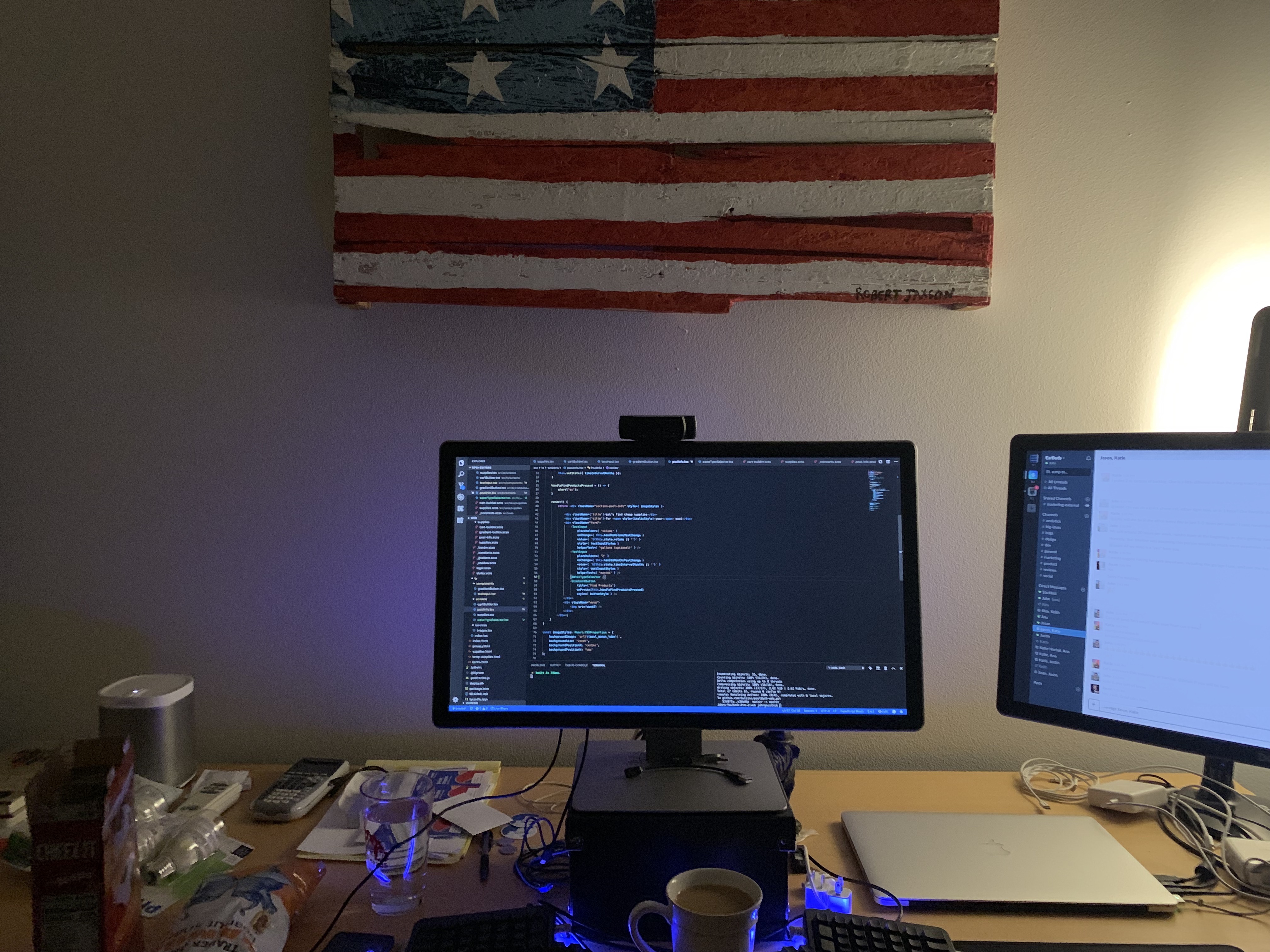 dual monitor desk with flag pallet behind