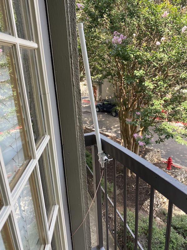 A big white antenna mounted on a little rail on a balcony... it doesn't inspire confidence haha