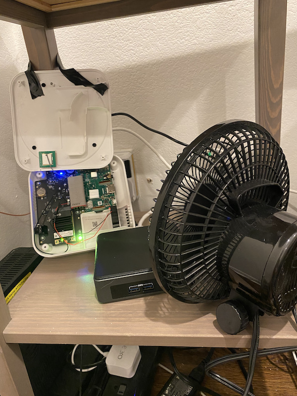An exposed circuit board with a table-top fan blowing it