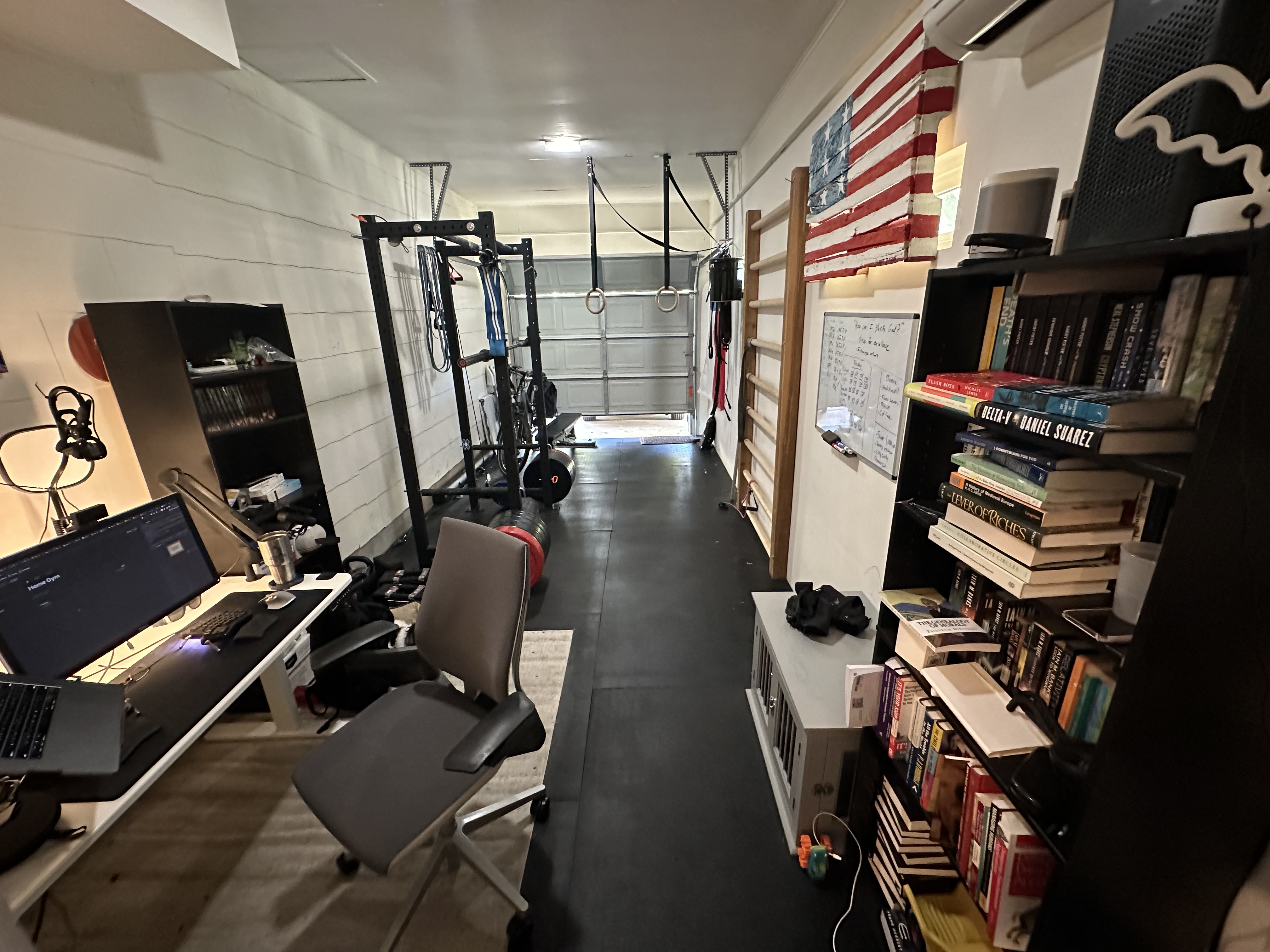 A desk next to a squat cage